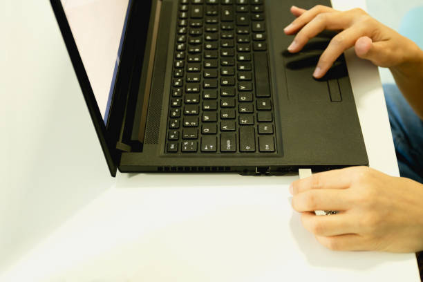 istock Woman hand plugging usb drive on laptop working in office. 1217084110