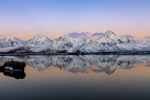 mountain kongka and its reflection in the lake at sunset time