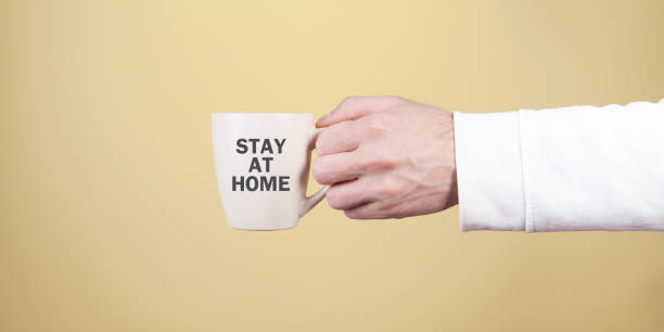 istock Man holding tea cup. Stay at home 1217086094