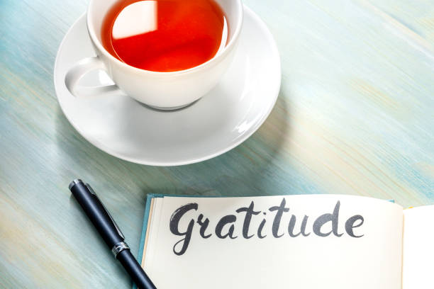 istock Gratitude journal with a pen and a cup of tea 1217086108