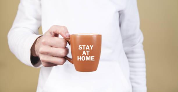 istock Man holding tea cup. Stay at home 1217086263