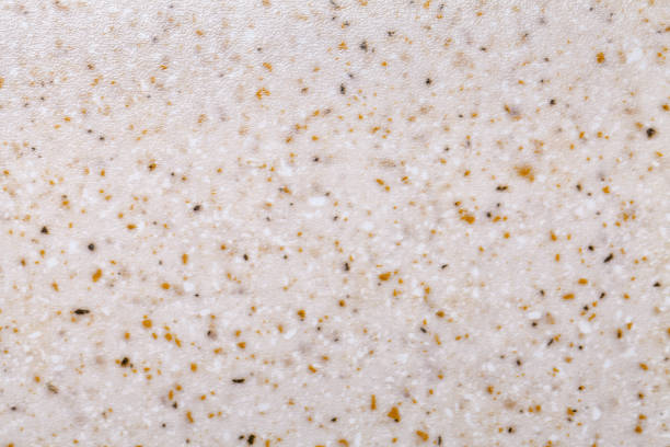 istock Grainy beige background with yellow and white spots. Texture backdrop with small crumb pattern. 1217087293