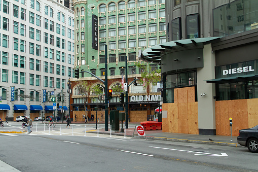 San Francisco, California - April 5th, 2020: Retail stores are boarded up in downtown during the Covid-19 pandemic.