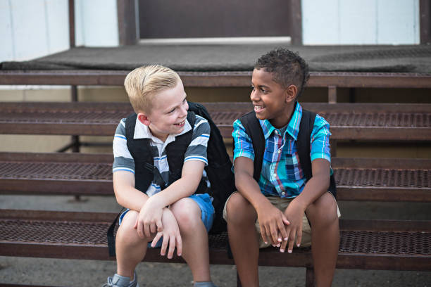 School Students talking together while sitting on the stairs at school