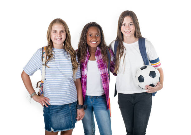 Portrait photo of a diverse group of smiling elementary school students standing together. Back to school photo. Shot on a white background