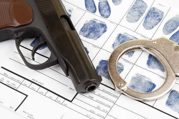 istock Fingerprint card with handcuffs and gun 1217091856