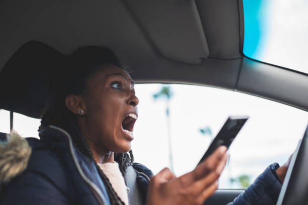 femme de conducteur choquée faisant défiler, utilisant un smartphone tout en conduisant une voiture juste avant un accident. - driving text messaging accident car photos et images de collection