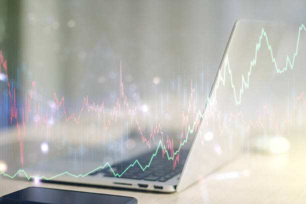 istock Abstract creative financial graph on modern laptop background, financial and trading concept. Multiexposure 1217094710