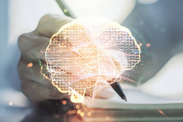 istock Creative artificial Intelligence concept with human brain sketch and woman hand writing in diary on background. Double exposure 1217094951