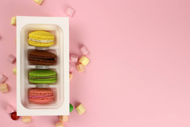istock Colored macaroons or macarons in a box. Free space for text 1217095074