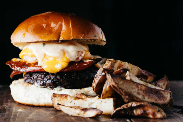 istock Oversized burger with chorizo and a fried egg served with french fries 1217095957