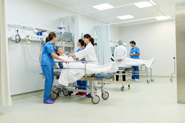 istock Wide angle view of the pre-operation ward with two patients, nurses and physicians. 1217096060