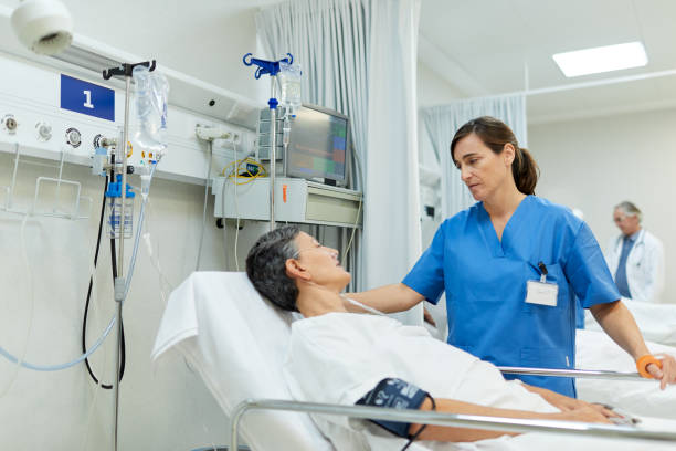 istock A patient on a gurney is telling the nurse how she is feeling. 1217096061