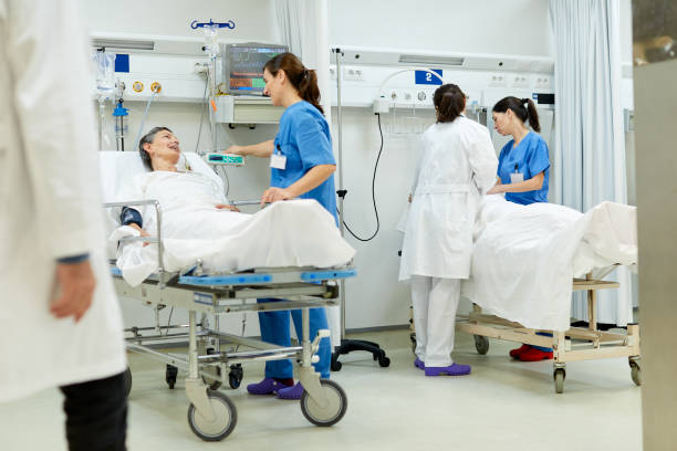 istock A nurse is talking with a patient lying down in the pos operative zone. 1217096069