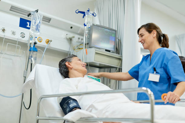 istock A nurse is talking with a patient lying down o a gurney. 1217096079