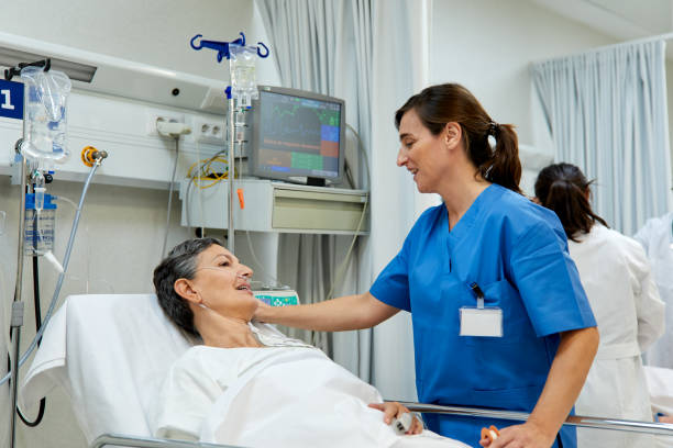 istock A nurse is talking with a patient lying down o a gurney. 1217096102