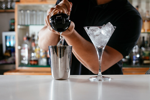 Barman making cocktails at bar