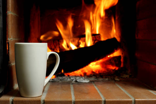 istock A Cup of hot coffee by fireplace 1217097859