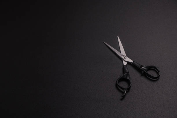istock scissors for cutting hair on a black background 1217097890
