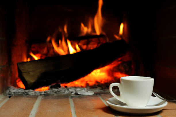 istock A Cup of hot coffee by fireplace 1217097916