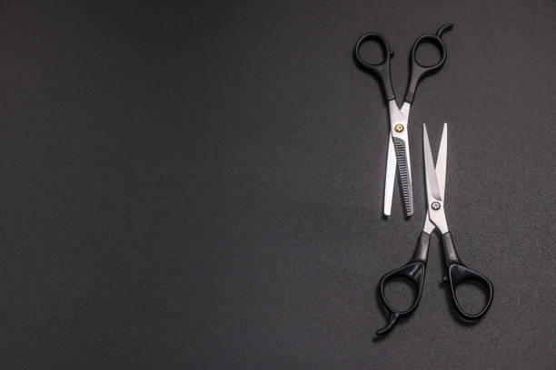 istock scissors for cutting hair on a black background 1217097943
