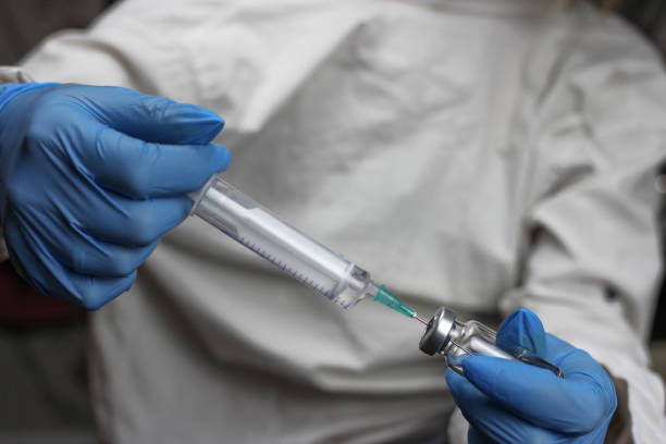 istock health worker dials the vaccine into a syringe 1217098763