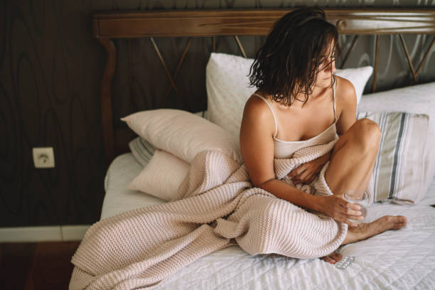 Sick young woman in bed. Sick young woman in bed. Woman have menstrual pain. headache menstruation pain cramp stock pictures, royalty-free photos & images