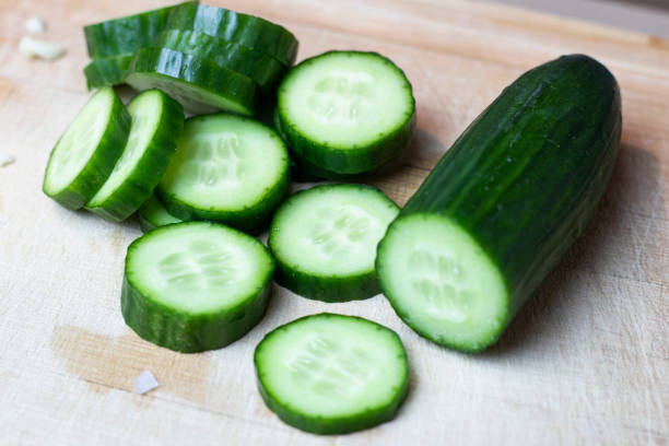 istock Cucumber slices on cutting board. 1217102555