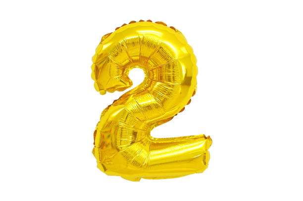 istock Golden Foil Balloon numbers in White Background 1217103102