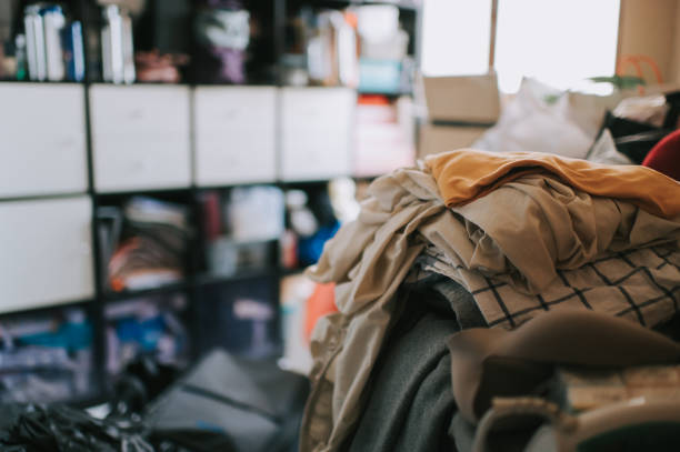 untidy domestic room full with unfolded and dirty clothes
