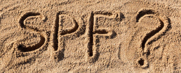 istock Sun protect factor concept. SPF word written on the beach with question mark 1217103656
