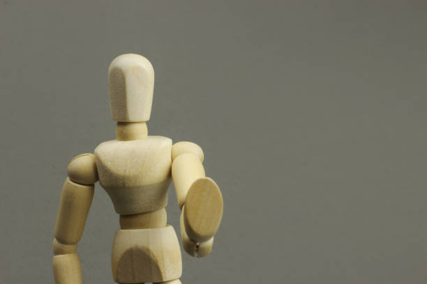 istock Wooden figure making stop sign on a gray background. Concept 1217104501