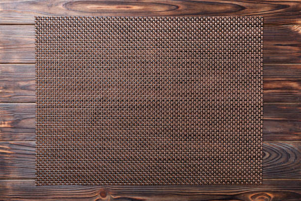 Top view of empty brown tablecloth on wooden background with copy space