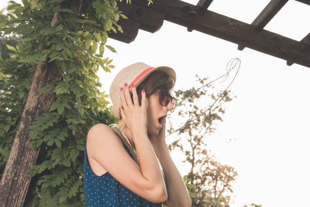 istock Cute young woman posing outdoors in summertime sunlight. 1217106436