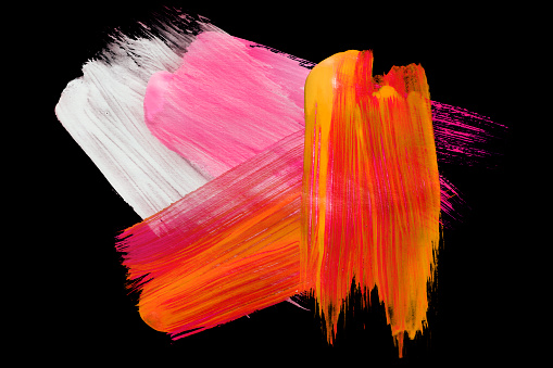 White pink and orange abstract paint brush strokes isolated over black