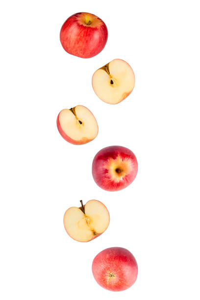 istock Falling red apples isolated on a white background with clipping path. Flying food 1217108434