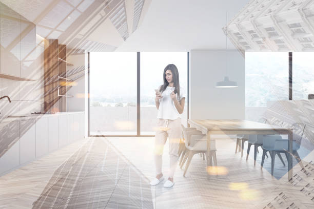 istock Young girl with coffee in white kitchen interior 1217109006