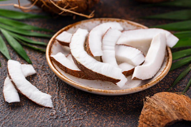 istock Sliced coconut and palm leaves 1217110370
