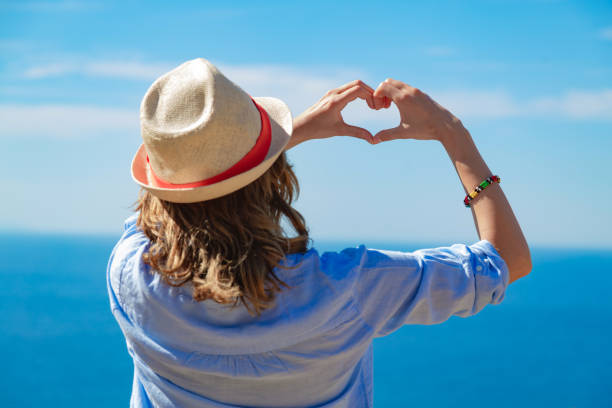 istock Woman in summertime with tropical ocean scenery. 1217110419