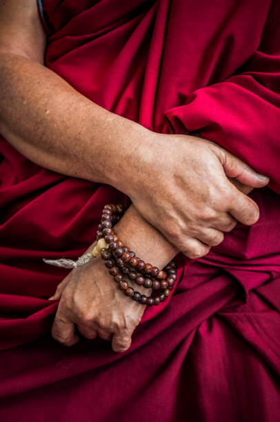 buddhist monk hands praying with necklace