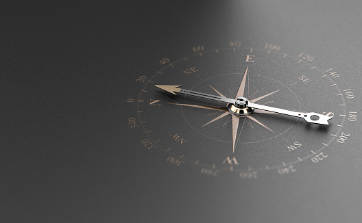 Business Guidance Or Orientation Concept. Compass over Black Background