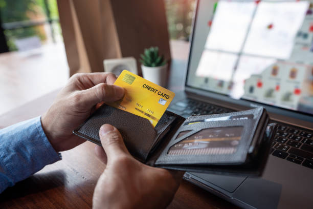 istock Man paying with credit card and entering security code for online shopping making a payment or purchasing goods on the internet with laptop computer, online shopping concept. 1217111364