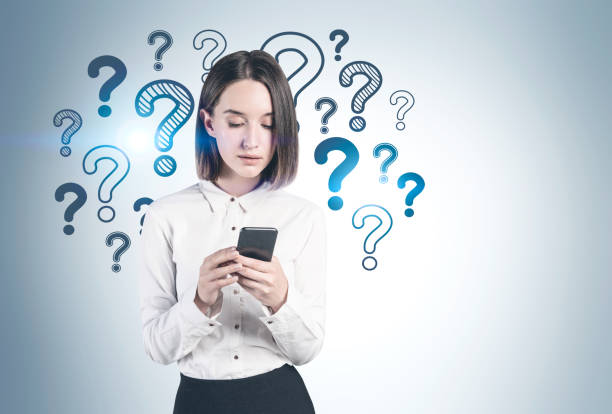 istock Woman with smartphone and question marks 1217113077