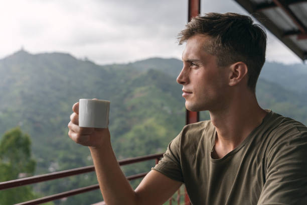 istock young handsome man tasting a teacup over the jungle in sri lanka 1217113266