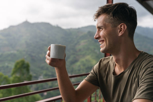 istock young handsome man tasting a teacup over the jungle in sri lanka 1217113298