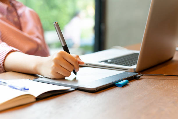 istock Graphic designer using digital tablet with laptop on the desk. 1217114332