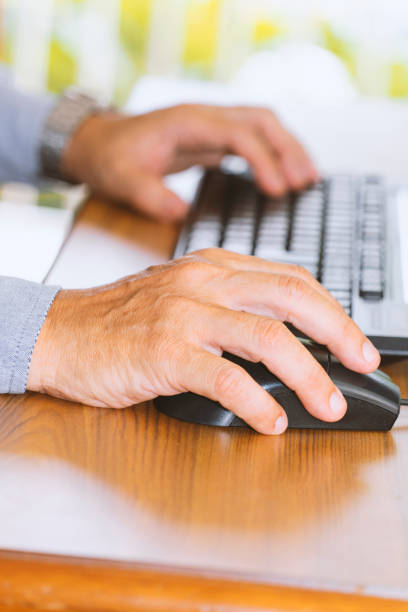 istock hand of elderly man works at home. 1217114336