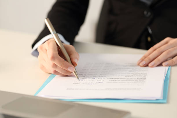 istock Executive hands filling form at the office 1217115171