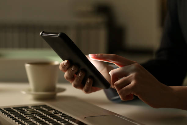 istock Executive woman hands using phone at night in the office 1217115186