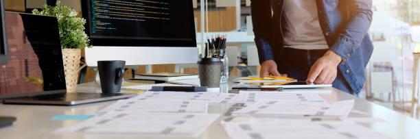 istock Cropped shot of male UI developer working on his project on white table 1217115254